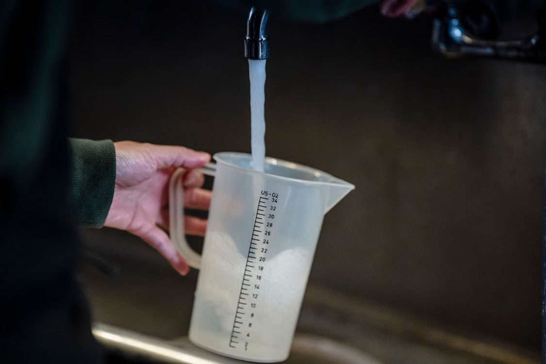 Filling a jug with water from the kitchen tap
